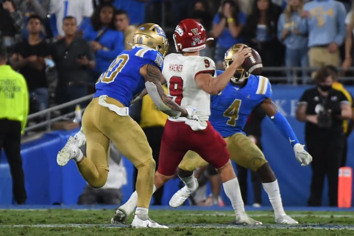 Fresno State Bulldogs quarterback Jake Haener (9) throws a pass as UCLA Bruins linebacker Ale Kaho (10) defends.